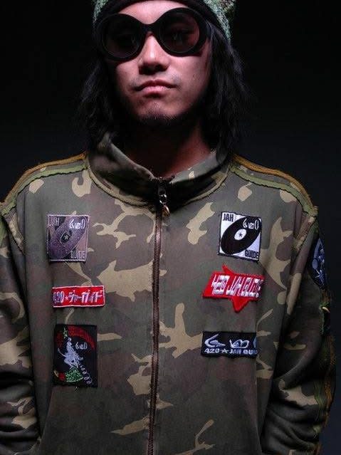 A camo jacket covered in sewn-on patches