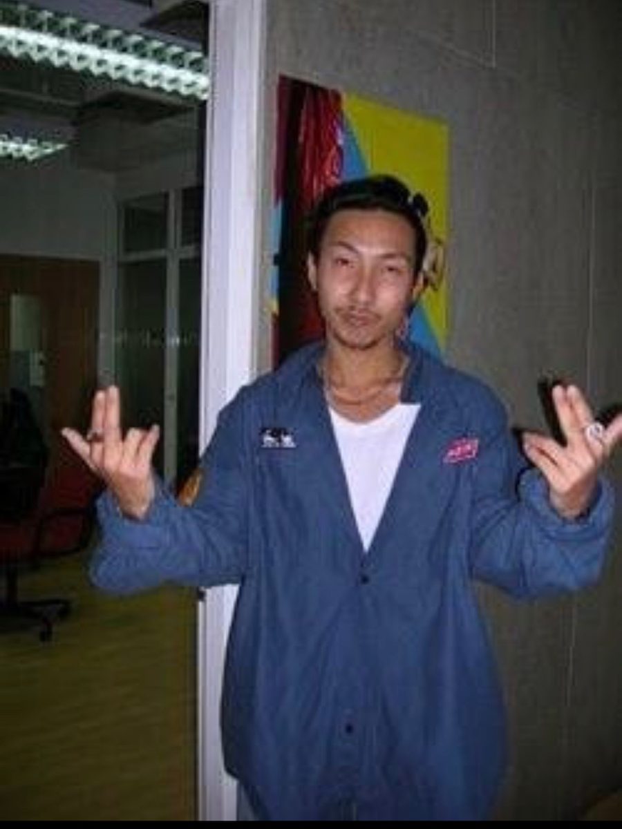 A staff member in the blue nylon jacket